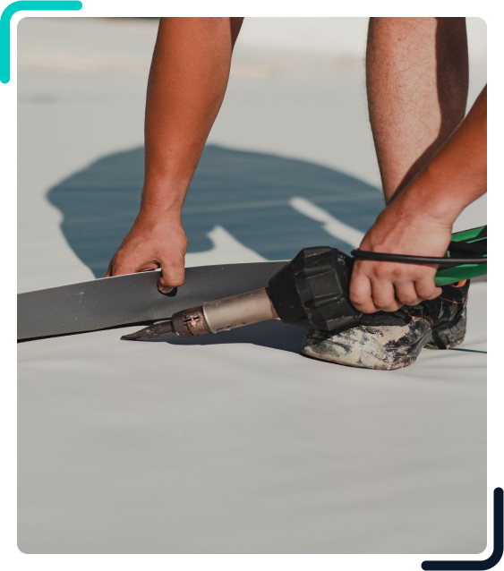 Here's an alt tag for the image: Worker heat welding roofing membrane.